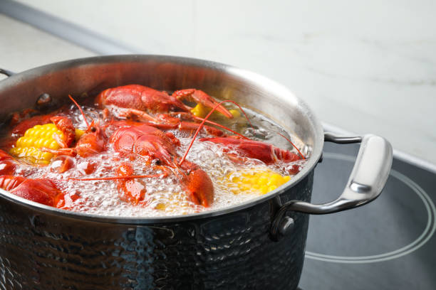 istock Fresh delicious crayfishes in boiling water on stove 1364550119
