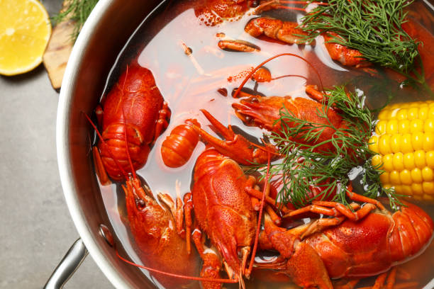 istock Fresh delicious crayfishes in pot on grey table, top view 1364552825