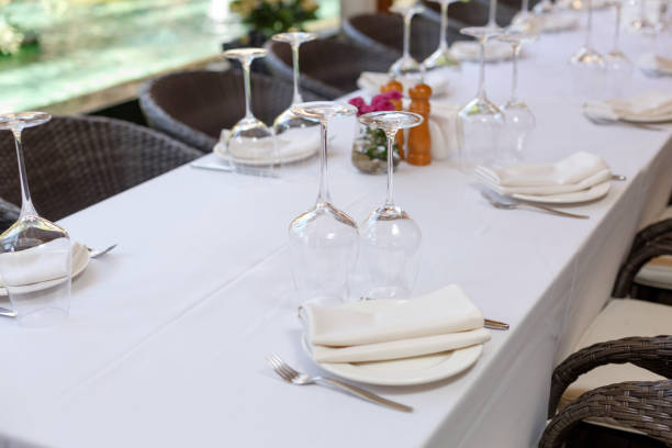 istock Table setting in restaurant. Plate, wine glasses and cutlery on a banquet server table with a white tablecloth 1364552833