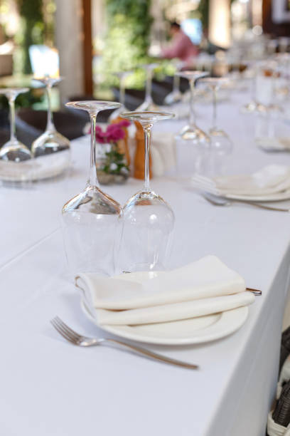 istock Table setting in restaurant. Plate, wine glasses and cutlery on a banquet server table with a white tablecloth 1364552834