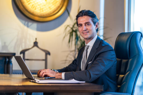 istock Cheerful young businessman working in the office 1364553904