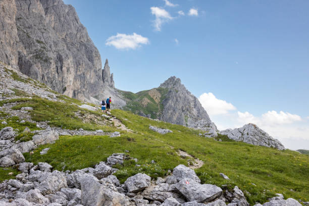 istock People hiking on a mountain slope in the Dolomites 1364554494