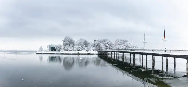 Pier of Lindau Lake Constance in winter with snow