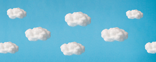 cloud made out of cotton wool on sky blue background.