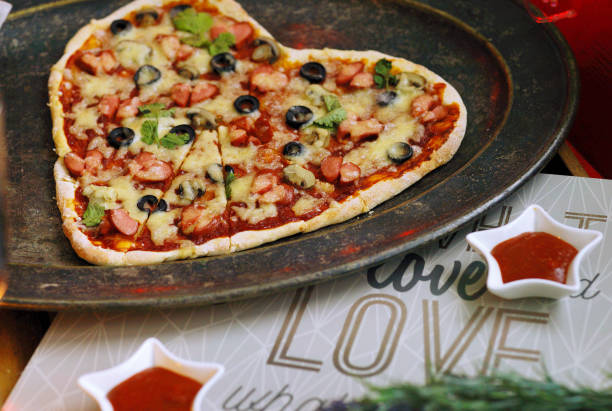 istock Pizza in shape of heart. Romantic dinner. For lovers. St. Valentin's Day celebration. Creative dish. 1364556817