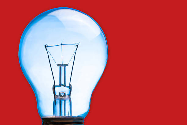 istock Light bulb isolated on red. Bright idea concept background. Electricity invention backdrop. 1364557858