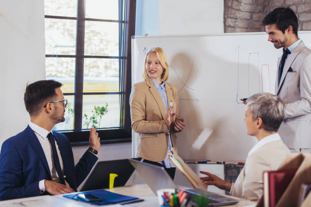 istock Business team brainstorming about new ideas on a whiteboard in the office 1364561310