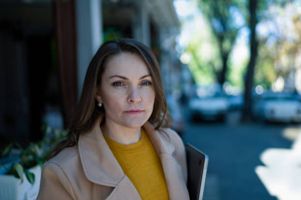 istock A middle-aged woman walks with a laptop in her hands 1364561623