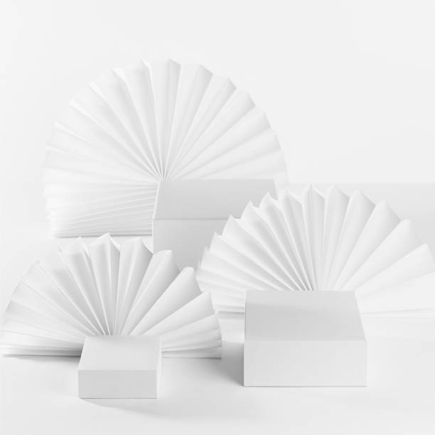 istock Abstract white stage template with three podiums on table for showing, presentation cosmetic product, goods, advertising with soft light paper fans in elegant fashion modern style, front view, square. 1364564331