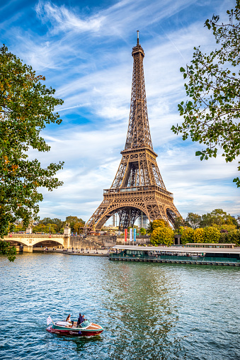 October 17, 2021 - Paris, France: Little boat with tourists at the afternoon in the Seine River enjoying the view of the Tour Eiffel in Paris