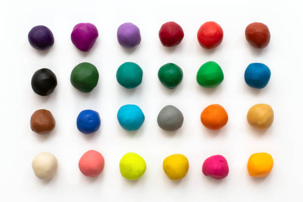 Pieces or balls of Colorful plasticine modelling clay isolated on white background. Top view with shadow. Creativity children toys concept. 24 colors set. Pieces or balls of Colorful plasticine modelling clay isolated on white background. Top view with shadow. Creativity children toys concept. 24 colors set. clay stock pictures, royalty-free photos & images