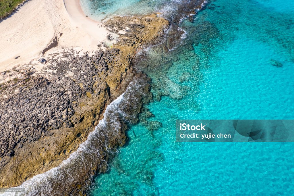 Aerial view of turquoise sea and rocky beach Aerial view of turquoise sea and rocky beach, Stocking Island, Great Exuma, Bahamas. Exuma Stock Photo