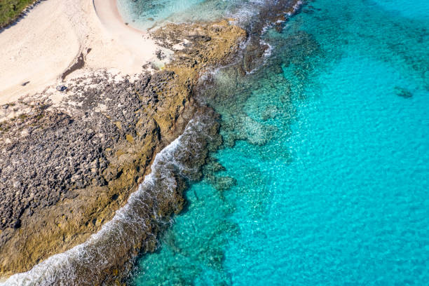 Aerial view of turquoise sea and rocky beach Aerial view of turquoise sea and rocky beach, Stocking Island, Great Exuma, Bahamas. exuma stock pictures, royalty-free photos & images