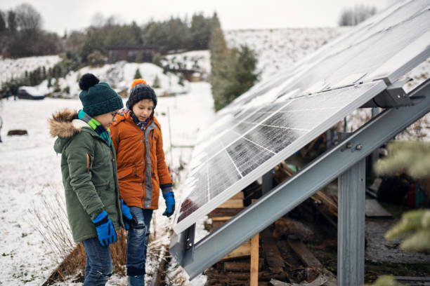 istock Two little boys discussing solar panels on a winter day. 1364565901