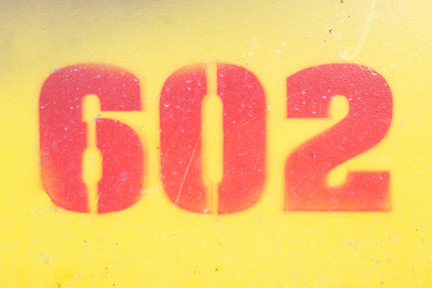 istock number 602 in red on yellow, painted in an irregular pattern on an iron base. graphic design resources 1364565942