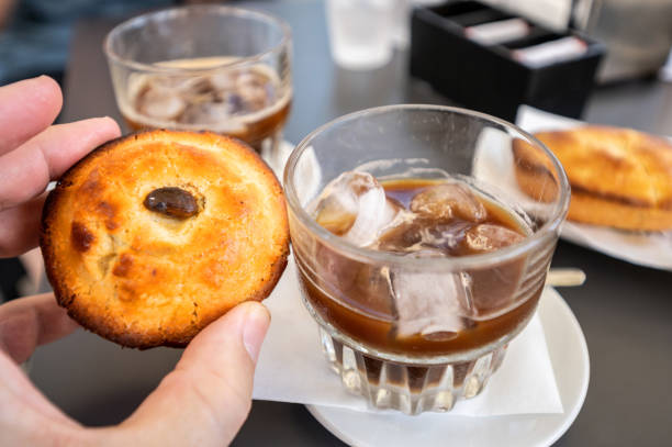 A greedy specialty of Salento, Puglia, Italy. A greedy specialty of Salento, Puglia, Italy. Coffee with ice and almond syrup accompanied by another local specialty: pasticciotto, a baked confectionery product that goes perfectly with it. lecce stock pictures, royalty-free photos & images