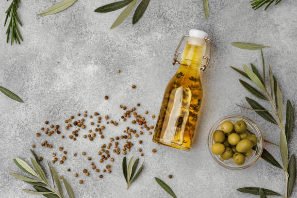 istock Glass bottle with olive oil on gray background 1364572400