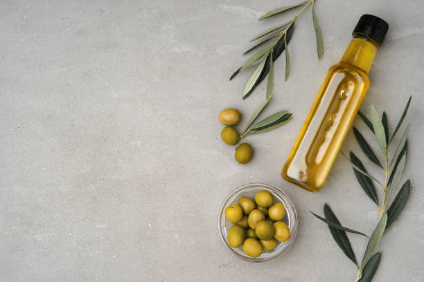 istock Glass bottle with olive oil on gray background 1364572595