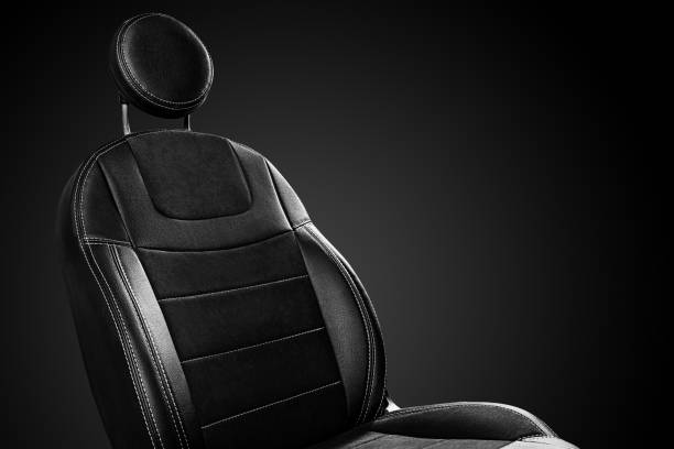 istock Comfortable front car seat back with round headrest on black background 1364573478