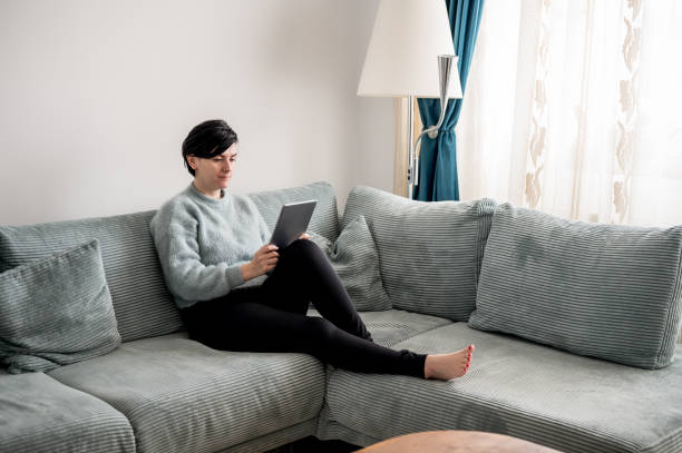 istock Young woman is resting on a sofa 1364573752