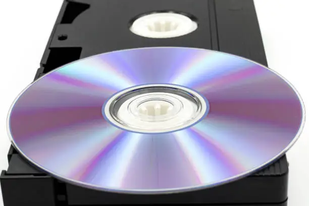 VHS video tape and DVD disk isolated on white