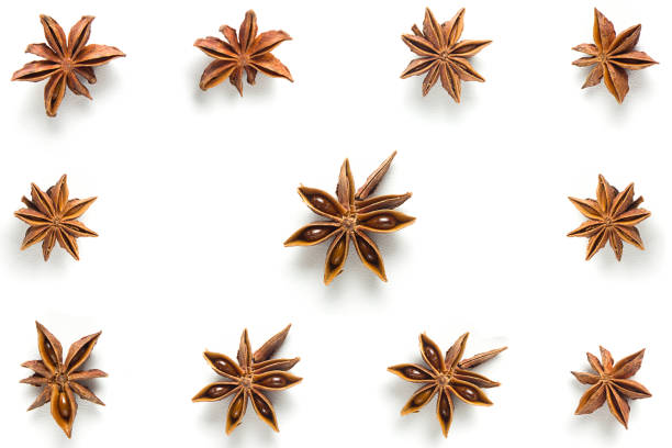 Star anise, scattered in a chaotic manner, isolated on white background stock photo