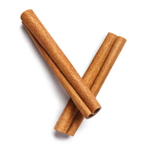 Photo of Two delicious cinnamon sticks on white
