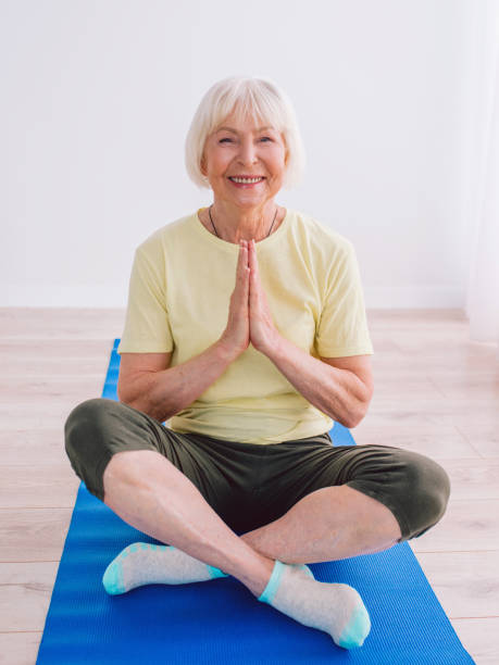 istock Senior woman doing yoga indoor. 1364578212