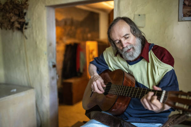 istock Skilled senior man playing acoustic guitar 1364578451