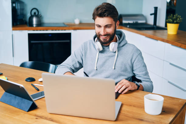 istock Smiling young graphic designer man working from home 1364578689