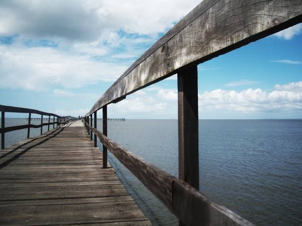 istock Wooden bridge beach blue sky 1364579589