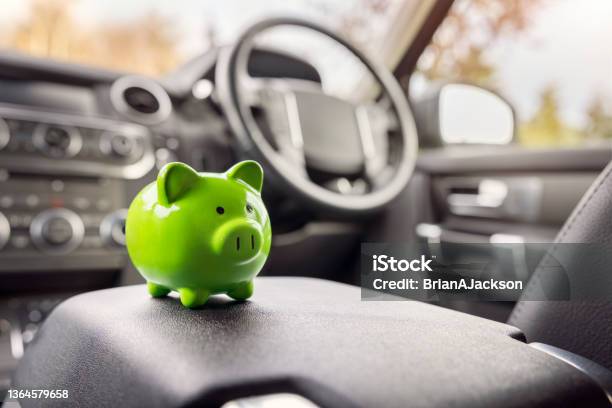 Green Piggy Bank Money Box Inside Car Vehicle Purchase Insurance Or Driving And Motoring Cost Stock Photo - Download Image Now