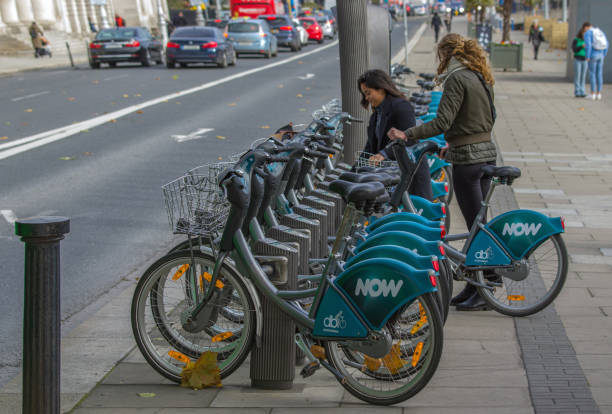 Front view of people riding bicycle in downtown O'Connell  street of Dublin Ireland during rush hour a day of autumn