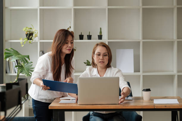 istock Business People Planning Strategy Analysis from financial document report, Asian middle age working together in office concept 1364584845
