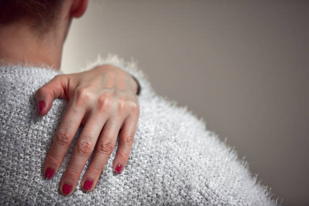 istock Woman with shoulder and back pain. 1364584974