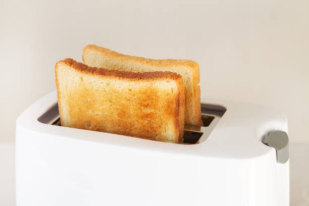 istock Sliced roasted toast bread in modern toaster on kitchen table 1364585373
