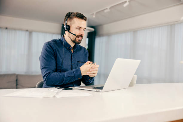 istock A technical support agent having video call on his laptop and working from home. 1364585773