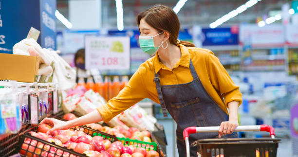 istock clerk put apples on shelf 1364585830