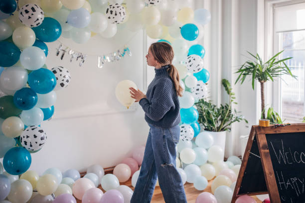 istock Young party planner arranging ballon decoration 1364586556