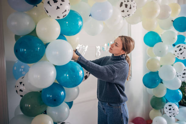 istock Young party planner arranging ballon decoration 1364586589