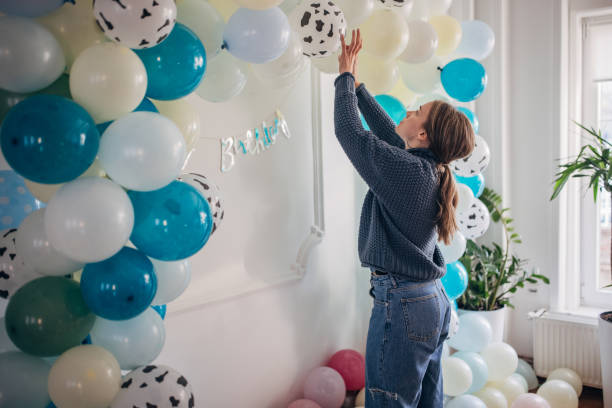 istock Young party planner arranging ballon decoration 1364586606