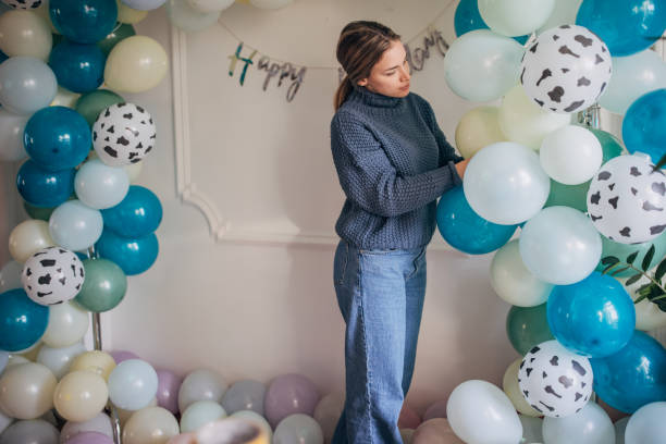 istock Young party planner arranging ballon decoration 1364586676