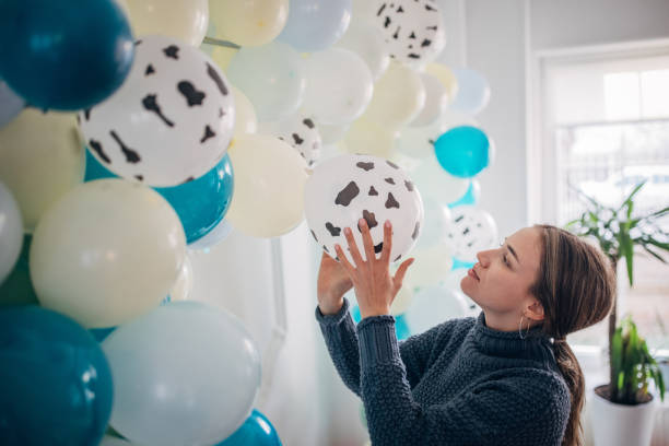istock Young party planner arranging ballon decoration 1364587357