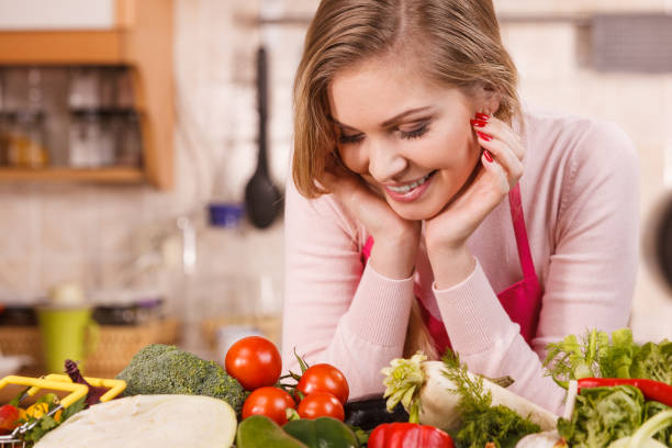 istock Woman having vegetables on table 1364587435