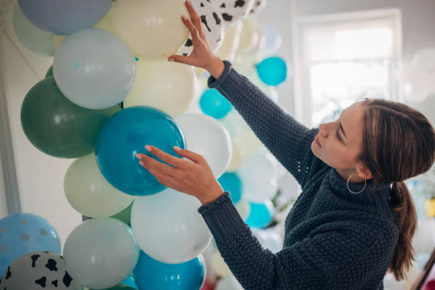 istock Young party planner arranging ballon decoration 1364587458
