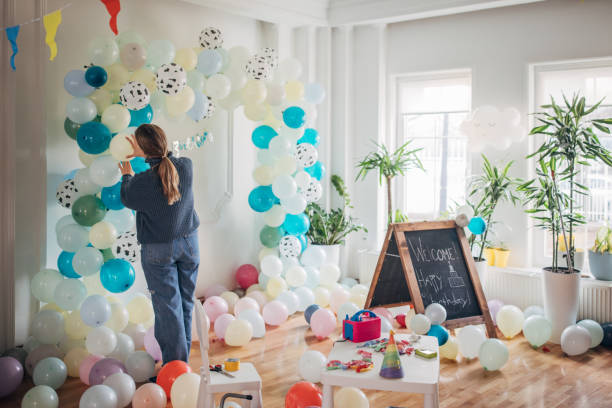 istock Young party planner arranging ballon decoration 1364587493