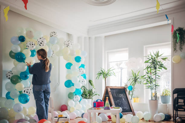 istock Young party planner arranging ballon decoration 1364587532