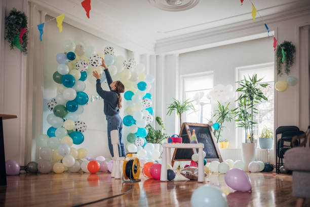 istock Young party planner arranging ballon decoration 1364587566
