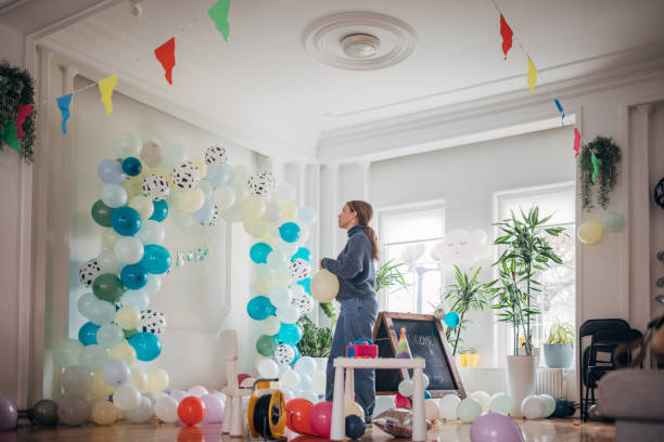Young party planner arranging ballon decoration