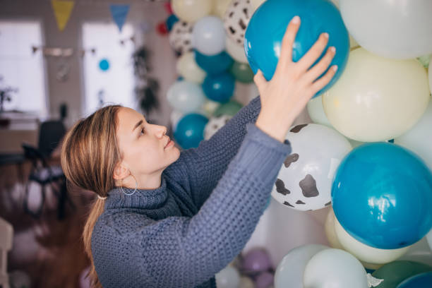 istock Young party planner arranging ballon decoration 1364587984